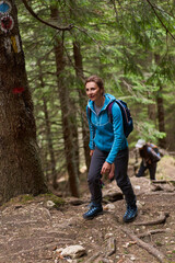 Obraz premium Group of hikers on a trail in the mountains