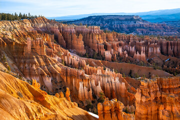 Bryce Canyon National Park in Utah (USA). Giant natural amphitheater panorama on a sunny winter morning. Colorful “Hoodoo“ structures, formed by frost and stream erosion. Attraction in warm light.