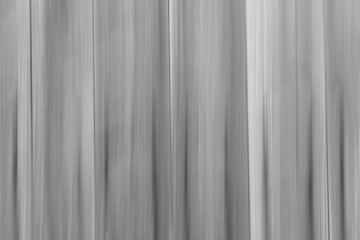 Obraz premium Intentional camera movement (ICM) image of a dream like black and white background of wood wall created by motion blur.