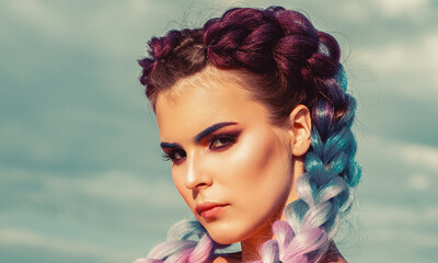 Girl braids on background sky. Bright makeup, rose-colored, braids, pigtails hairstyle