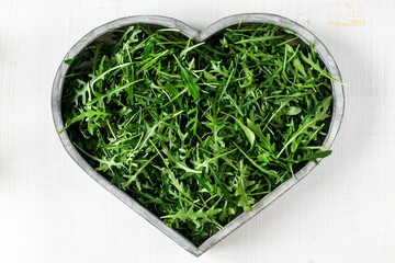 Heartshaped Wooden Bowl With Fresh Arugula Leaves Healthy Eating Concept