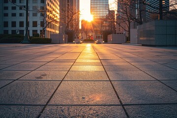empty square concrete floor of a modern downtown with bright light coming during sunset from the...