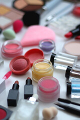 Various colorful beauty products on white background. Selective focus.