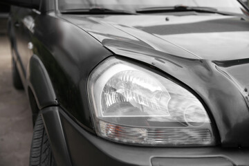 headlight of a black car, beautiful headlight close-up

