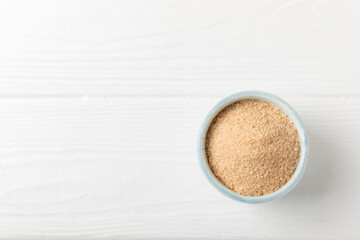 Cinnamon sugar on a texture background. Homemade cinnamon sugar in a bowl on background. Brown sugar. Spice mixture for drinks and baking. Place for text. Copy space.