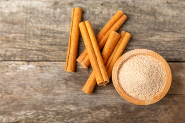 Cinnamon sugar on a texture background. Homemade cinnamon sugar in a bowl on background. Brown sugar. Spice mixture for drinks and baking. Place for text. Copy space.