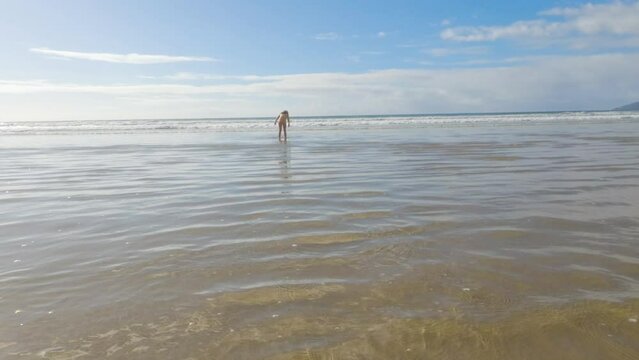 Little Girl Joyfully Running on Winter Beach