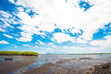 Vast sky over the dry lands at "Morazán" port, "Real" estuary. Volcanoes in the horizon. Summer days in Nicaragua, Central America. Water connection to the Pacific Ocean. Tropical environment.