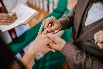 Valmiera, Latvia- July 28, 2024 - Exchanging wedding rings during a ceremony, hands close-up.