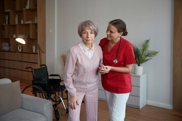 Young daughter caring for retired mom with physical or mental disorder