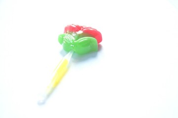pink rose lollipop candy stabbing in plastic stick on white background