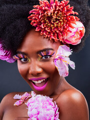 Beauty, flowers and surprise with portrait of black woman in studio on dark background for natural...