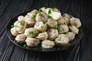 fresh cooked dumplings on a black wooden rustic background