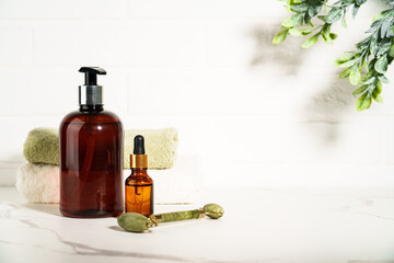Beauty products in the bathroom on white background. Soap, serum bottle, jade roller. Skin care. - 787137039