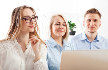 Within the office environment, a skilled businesswoman is educating and mentoring young employees.