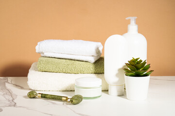 Spa products in the bathroom. Shampoo, cream, towels. Natural cosmetic background. - 787144847