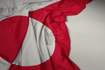 waving national flag of greenland on a gray background.