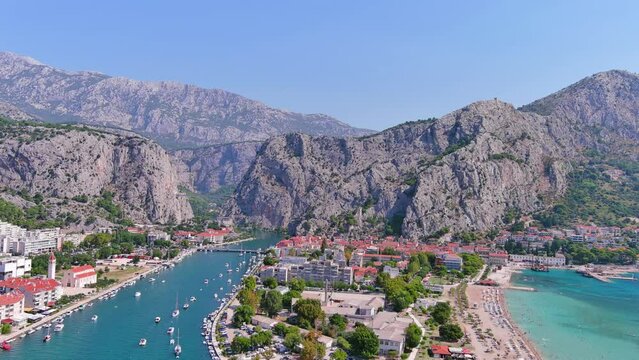 Omis, Croatia: Aerial view of famous Mediterranean town and tourist summer resort by Adriatic Sea, summer day with clear blue sky - landscape panorama of Europe from above
