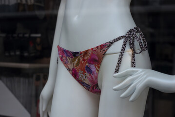 Closeup of printed cheeky of bikini on mannequin in a fashion store showroom - 787145236