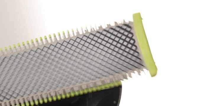 Closeup of an electric shaver blade moving in slow motion