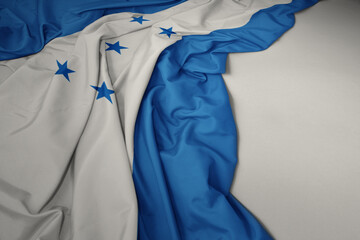 waving national flag of honduras on a gray background.