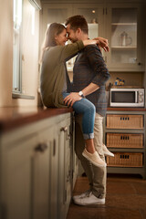 Love, happy and couple hug in kitchen for bonding, loving relationship and relax together in home....