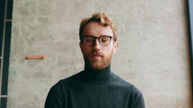 A young red-haired guy, in a stylish cafe. Vlog recording, online video conference, video call, online learning, lessons, lecture. Interview, online training. View from the webcam.