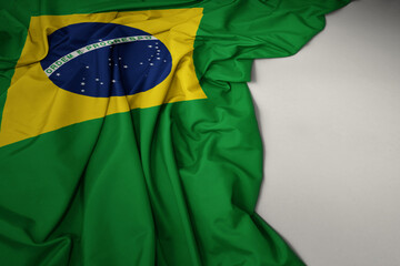 waving national flag of brazil on a gray background.