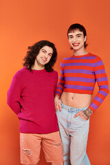 good looking stylish jolly gay friends in vibrant clothes posing happily together, pride month