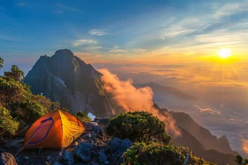 Dekokissen A tent perched atop a mountain at sunset amidst a stunning natural landscape © Александр Раптовый