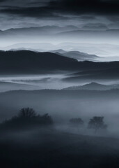 mysterious hills in fog at night, dark fantasy landscape - 787155286
