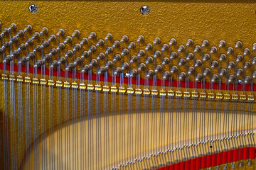 Close-up of open brown wooden piano with strings and screws standing in living room at Swiss City of Zürich. Photo taken April 17th, 2024, Zurich, Switzerland.