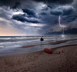 Lifeguard tower inundated by sea during lightning storm in Poland. - obrazy, fototapety, plakaty