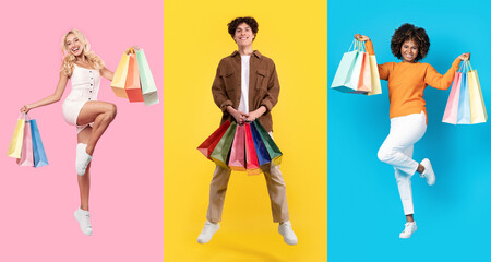 Three Happy Shoppers With Colorful Bags Jumping Against Colorful Backgrounds