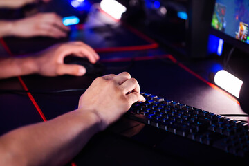 Skill Close up player's hands use professional gaming mouse and PC keyboard with RGB lighting, mat. E-sport tournament with cyber team in computer club. Gamers play video game. Strategy shooter - 787160850