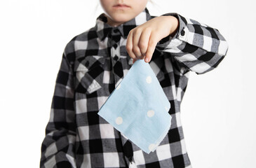 A girl in a plaid shirt holds a handkerchief against the background of the shirt. Concept of allergic and bacterial rhinitis in children. Adenovirus and staphylococcus, close-up - 787161258