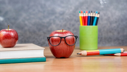 back to school concept , World teacher day - apple and books with pencils and eyeglasses on table...