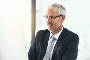 Fototapeta premium Computer, glasses and mature businessman in office for web, research and b2b, client or communication. Pc, review and CEO reading company newsletter, planning or checking email, schedule or feedback