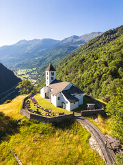 Aerial view of San Martino Church in Calonico during summer day, Leventina, Switzerland