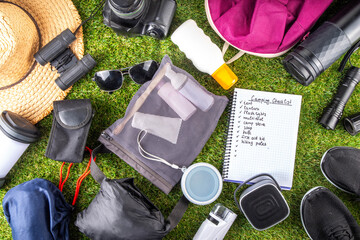Camping checklist with various camp equipment. List of things for outdoors recreation and travel in nature - tent, first aid kit, cosmetics, accessories, equipment, clothes, trekking shoes - 787166679