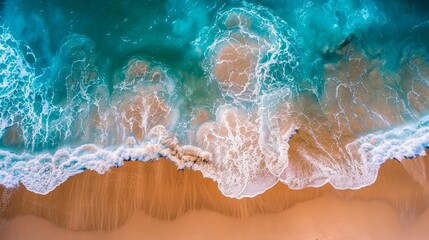 Top-down perspective of turquoise ocean waters gently lapping onto a golden sandy shore with foamy waves - obrazy, fototapety, plakaty