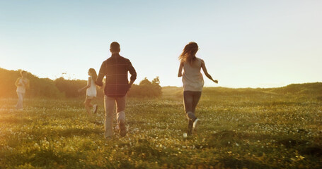 Freedom, travel and family running on field with energy, love and fun bonding in nature together....