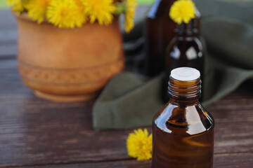 Flower and dandelion extract. Medicinal wild plants and medicinal tincture from it. Bottles of...