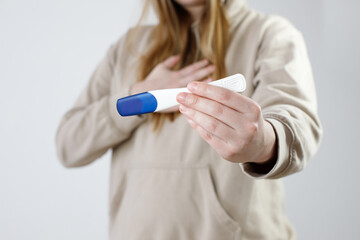 woman with pregnancy test not happy