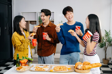 Group of Young Asian friend having, enjoy evening party together at home. Attractive young man and woman having fun, eating food, celebrate at home