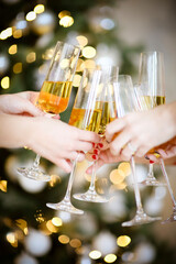 Crop women proposing toast during Christmas party