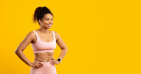 Confident black lady in fitness attire isolated