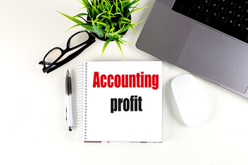 ACCOUNTING PROFIT text on notebook with laptop, mouse and pen