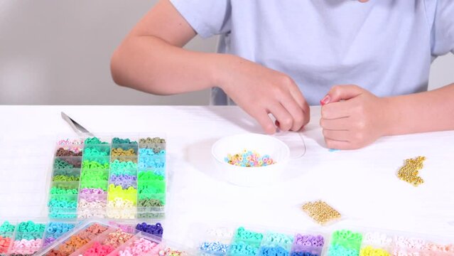 Young Girl Engrossed in Crafting with Colorful Clay Beads