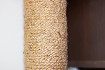 Close up of a wooden cat scratching post crafted with rope